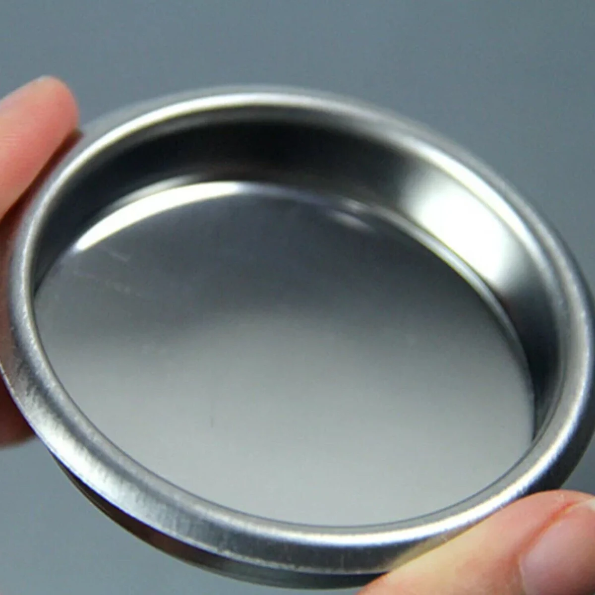 58 mm Blind Filter Basket, held in hand