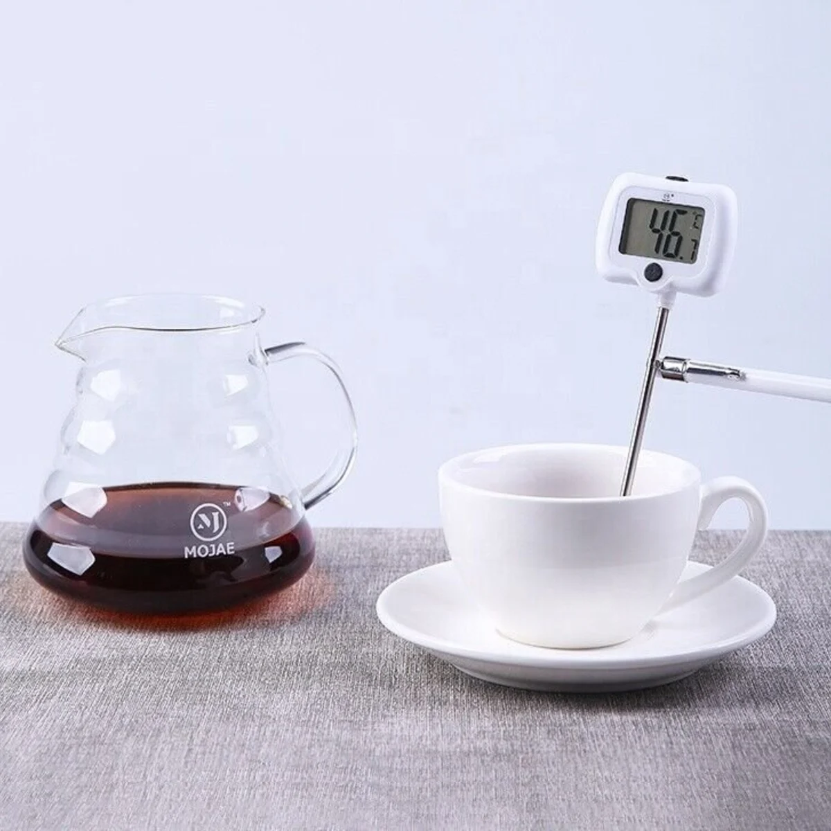 Checking drink temperature with a digital thermometer