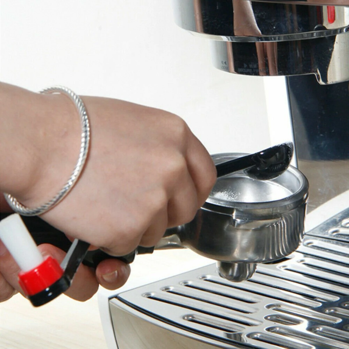 Espresso Group Head Cleaning Brush, scooping into the basket